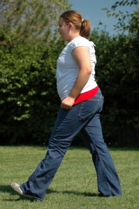 US Teen with Type 2 Diabetes Walking Fast.  Her waist is larger than her hips.