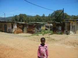 Child with pot belly and thin arms in neighborhood near ghetto orphange for AIDS