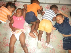 Nap time for 5 toddler age orphans living with HIV.  The children appear to be average weight and height for their age.